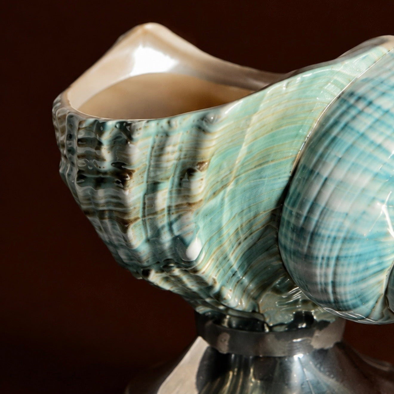 Close-up of green turban seashell footed dish, natural texture