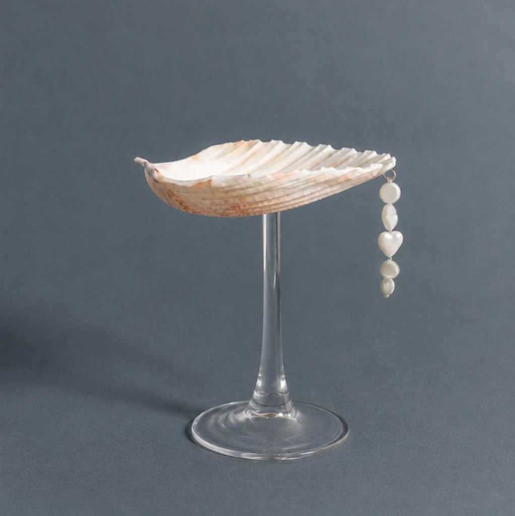 Scallop shell coupe on glass stem with pearl bead charm, full view
