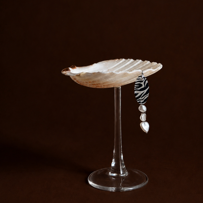 Scallop shell coupe on glass stem with zebra charm, full view